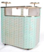 A 1950's retro cocktail cabinet bar of shaped form with vinyl upholstered ' disco ' facia having
