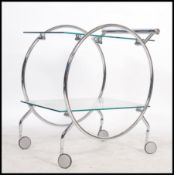 A 1930's style Art Deco chrome and glass butlers serving trolley. Raised on castors with circular