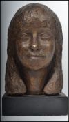 A 20th century plaster study bust of a young lady being raised onto square plinth wooden ebonised