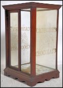 An early 20th  Cadbury's Chocolate shop advertising table top glass display cabinet, The oak frame