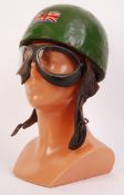 A rare and original early 20th century motor racing helmet and goggles set. The green helmet with