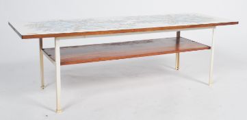 A 1960's / 1970's Terence Conran for Habitat longjohn coffee table being raised on painted metal