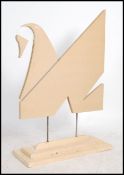 A contemporary handmade advertising point of sale swan sculpture constructed of panel wood and