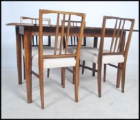 A 1950's Gordon Russell Llimited of Broadway, a believed laurel wood dining suite comprising of a
