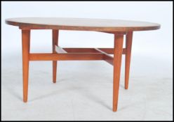 A good mid century Gordon Russell of Broadway retro coffee table of circular form being raised on