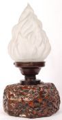A 20th century flame table lamp. The frosted glass olympic frame shade raised on a resin cast