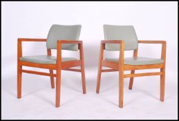A superb pair pf 1970's Retro Danish inspired teak and black vinyl upholstered War Department -