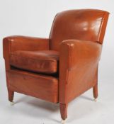 An exceptional 1930's Art Deco tan brown leather French club armchair being raised on leather