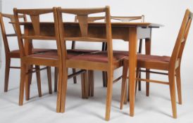 A good mid century Alfred Cox walnut / laurel wood extending dining table and 6 chairs suite. The
