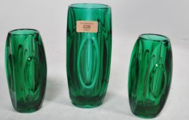 A 1960's retro 3 piece bullet glass garniture. The vases of green glass construction with
