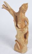 A large decorative Indonesian carved hardwood sculpture of an Iguana - Lizard modeled climbing a