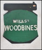 An early 20th century painted double sided metal advertising sign for Wills Woodbine cigarettes in a