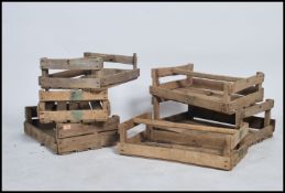 A collection of 5 unusual wooden mid century apple crates of slatted construction having carry