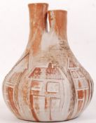 A stunning 20th century studio pottery lamp base modelled as a Northern Town scene the twin neck