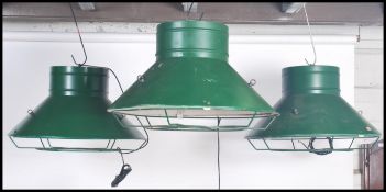 A set of three vintage 20th century oversized industrial factory pendant ceiling lights, finished