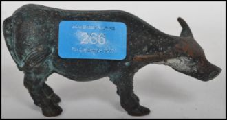 An early 20th century bronze figurine of a cow / y