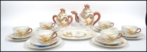 An Oriental ceramic six person tea service decorat