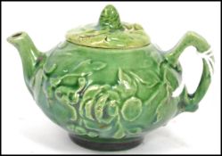 A 19th century Oriental ceramic Yi Xing tea pot of globular form having a green textured