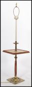 A 20th century brass and walnut standard lamp / occasional table raised on a brass and walnut base