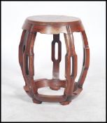 An early 20th century hardwood barrel / opium stool having a silver inlay / stencil top depicting