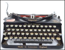 A vintage early 20th century Imperial typewriter of metal construction with ebonised finish, push