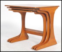 A vintage retro 20th century Danish influence G-plan style teak wood nest of tables having panel