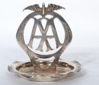 A silver plated 1930s motoring related AA badge ashtray having a scalloped edge with eagle wings