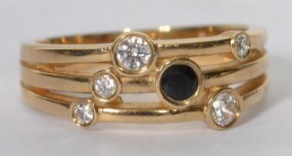 A contemporary hallmarked 9ct gold band ring set with a sapphire and CZ. Hallmarked Birmingham. Size