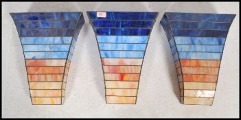 A set of three vintage 20th century Art Deco style stained glass panelled light fixture wall mounted