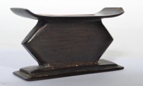 A 20th century hardwood miniature ashanti stool - headrest being raised on a stepped square base