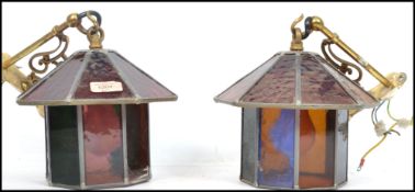 A pair of 20th century hanging porch lantern of octagonal form having leaded stained glass panels.
