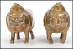 A pair of 19th century Victorian lead filled brass novelty pig paperweights. Measures: 4cm high x