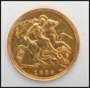 A 20th century gold half sovereign coin dating to 1982,  weighs 3.99 grams. Measures 2 cm diameter.