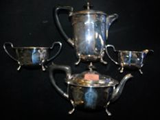 A four piece early 20th century A1 silverplate tea service having ebonised handles along with a