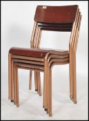 A set of four vintage mid 20th century gilt metal tubular stacking chairs, vinyl seat pads and