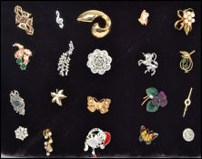 A collection of twenty costume jewellery brooches