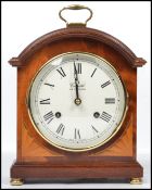 A Comitti of London mahogany cased bracket clock having a key wind mechanism striking on a bell with