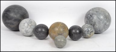 A collection of 20th century large marble carved balls - spherical globes of varying sizes and