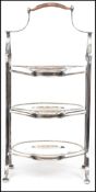 A Mappin and Webb silver plated cake stand having three tiers with circular plates and scrolled