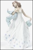 A Lladro ceramic figurine of a lady entitled ' Summer Serenade ' with impressed marks to base