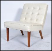 A vintage retro 20th century Mies Van De Roe inspired white cream button back chair raised on shaped