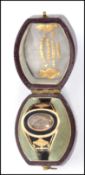 A George III Enamel, gold and hairwork mourning ring, the black enamel with white border lozenge