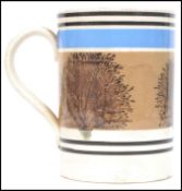 A 19th century Mocha ware tankard having a white ground with blue and black banded decoration and