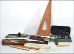 A large collection of vintage 20th century Draughtmans drawing tools to include slide rules, set