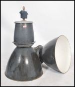 A pair of large vintage industrial 20th century factory black enamel ceiling lights. Each  retaining