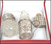 A group of three silver hallmarked perfume vials to include a miniature french example in the form