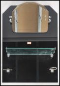 A 1930s Art Deco black glass bathroom mirror with original chrome fittings and glass shelf in good