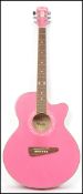 A Carlo Robeli vintage Carly six string acoustic guitar in pink having a shaped hollow body.