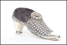 A 20th century silver hallmarked novelty pin cushion in the form of a Georgian shoe having a black