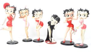 Two vintage 20th century Betty Boop figurines depicting the iconic character in pink outfits